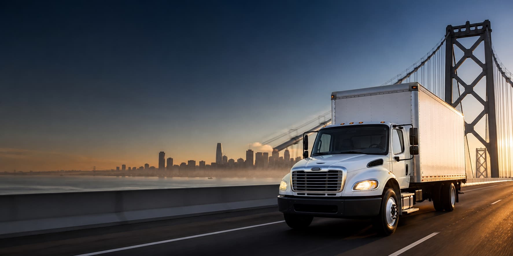 White box truck crossing the Bay Bridge with the San Francisco skyline beyond